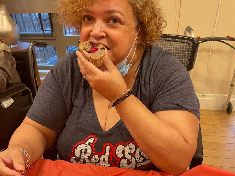 A resident enjoys a muffin she helped make.