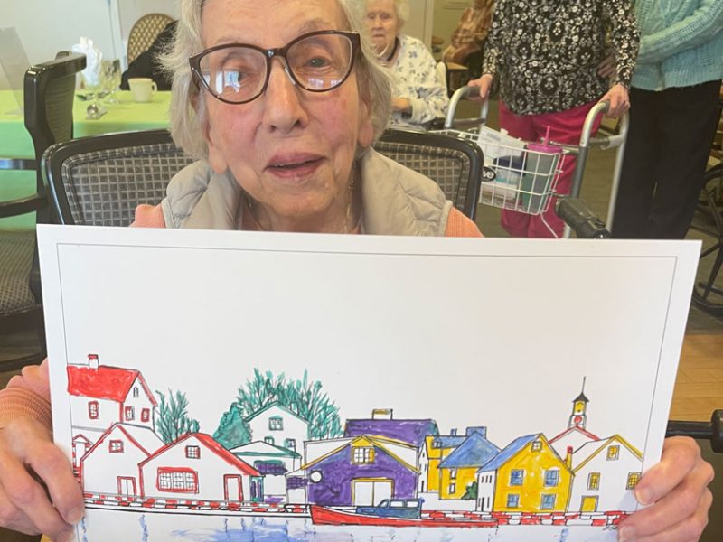 Residents enjoy painting a picture of a row of houses.