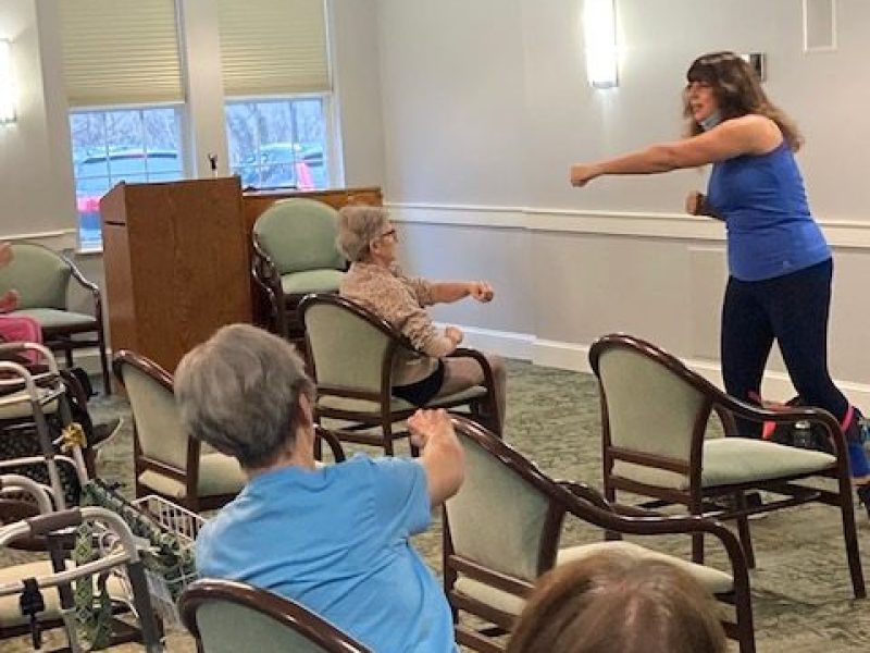 Residents in Peabody enjoy exercise class.