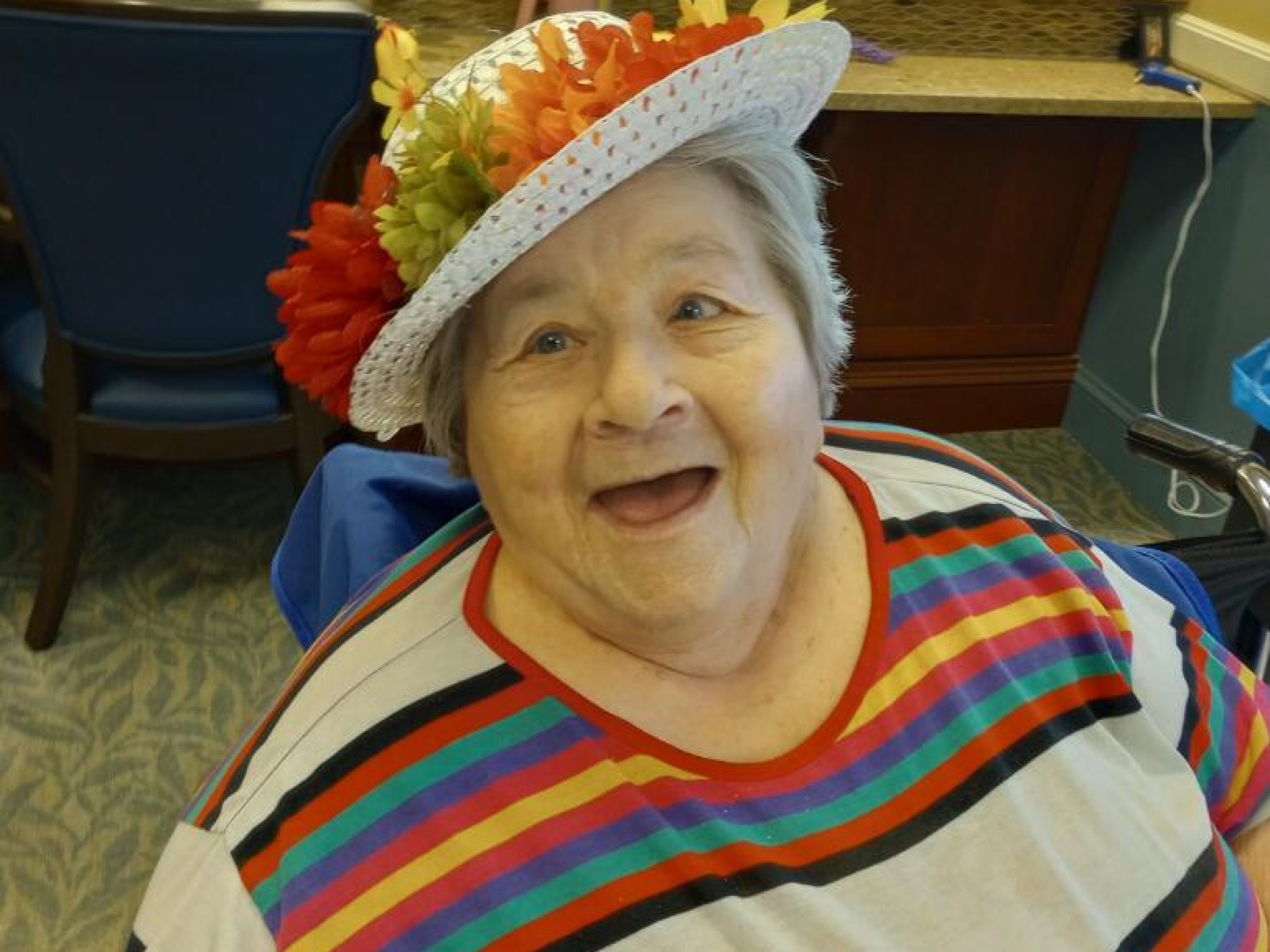 A resident of Chelsea Jewish happily modeling her Kentucky Derby Hat